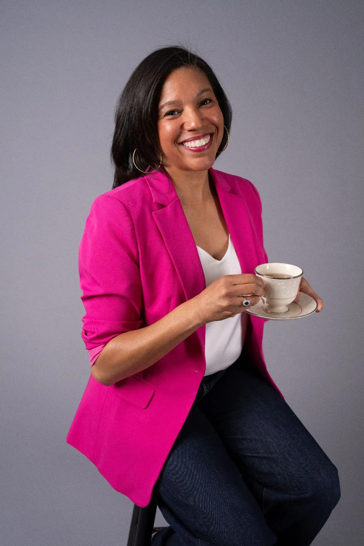 Cecelia Curtis in a pink blazer holding a teacup