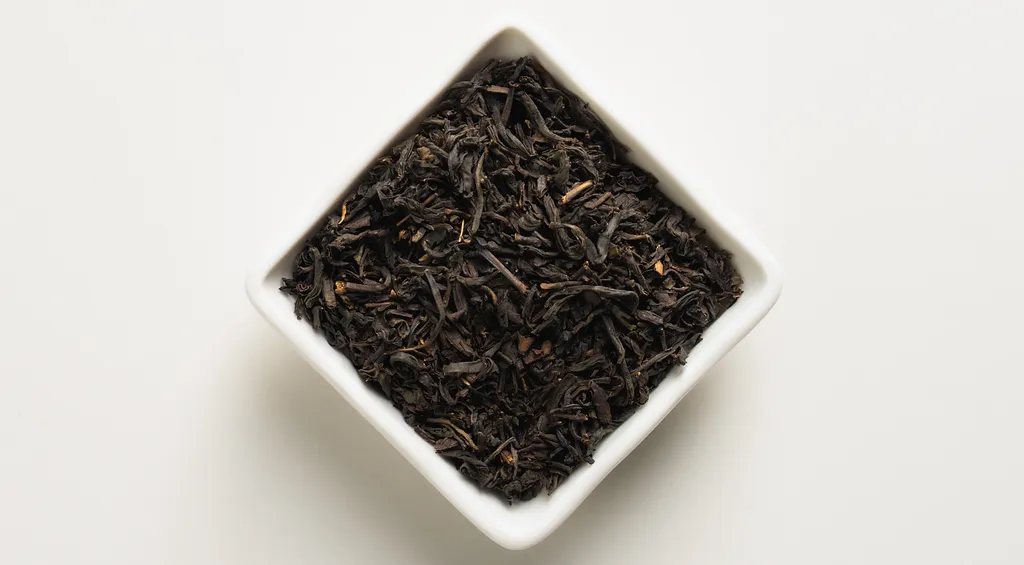 Timeless Grey loose-leaf tea in a white square dish on a clean near-white background.